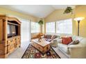 Bright living room featuring large windows, comfortable seating, and a decorative area rug at 6001 S Yosemite St # B203, Greenwood Village, CO 80111