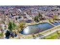 Aerial view of the property at 6882 Quail St, Arvada, CO, showcasing the surrounding neighborhood and a tranquil pond at 6882 Quail St, Arvada, CO 80004