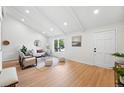 Bright living room with vaulted ceilings, modern furniture, large windows, and stylish decor at 5616 S Kenton Ct, Englewood, CO 80111