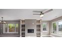 Bright living room boasts a ceiling fan, a fireplace, and large picture windows at 2008 S Galapago St, Denver, CO 80223