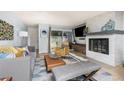 Cozy living room features a modern fireplace, comfortable seating, and a sliding door to the patio at 6600 E Mississippi Ave # 7, Denver, CO 80224