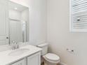 Clean, bright bathroom with a glass-enclosed shower, white vanity, and modern fixtures at 449 S Salida St, Aurora, CO 80017