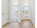 Bright entryway featuring a modern door with glass panels and light wood flooring at 449 S Salida St, Aurora, CO 80017