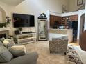 Inviting living room with a fireplace, large TV, and open access to the kitchen at 15501 E 112Th Ave # 28E, Commerce City, CO 80022