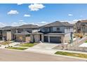 Beautiful two-story home with stone accents, manicured lawn, and a two-car garage at 7240 S White Crow Way, Aurora, CO 80016