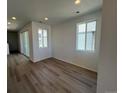 Bright living room featuring wood-look floors and a sliding glass door for natural light at 6599 N Netherland St, Aurora, CO 80019