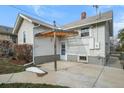 Backyard featuring a small covered patio and partial privacy fence at 3226 S Grant St, Englewood, CO 80113