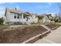 Street view of a home with a covered front porch and landscaping at 3226 S Grant St, Englewood, CO 80113