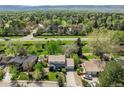 Two story home with front lawn, mature landscaping, and attached garage nestled in a green neighborhood at 4667 Ashfield Dr, Boulder, CO 80301