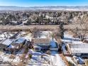 An aerial view shows a home with a two-car garage, snow-covered roof, and a spacious driveway in a residential neighborhood at 4667 Ashfield Dr, Boulder, CO 80301