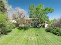 Charming home nestled among mature trees, set back on a well manicured lawn, creating a peaceful and private setting at 4667 Ashfield Dr, Boulder, CO 80301