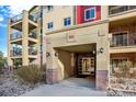 A well lit entrance to building 1144 with brick accents and secure entry at 1144 Rockhurst Dr # 401, Highlands Ranch, CO 80129