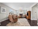 Inviting living room with a stone fireplace, hardwood floors, and comfortable leather furniture at 224 S Jackson Gap Way, Aurora, CO 80018