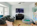 Cozy living room featuring comfortable seating, a piano, and a large TV for entertainment at 764 S Osage St, Denver, CO 80223