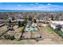 Expansive aerial view of the property showcasing a large yard, tennis court, and mountain views at 6192 S Pennsylvania St, Centennial, CO 80121