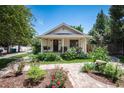 Charming exterior of a well-maintained home with inviting front porch and lush landscaping at 6192 S Pennsylvania St, Centennial, CO 80121