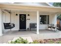 Inviting front porch with a swing, bench, and stylish accents, perfect for relaxing at 6192 S Pennsylvania St, Centennial, CO 80121