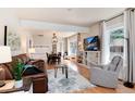 Open-concept living room with hardwood floors and modern furniture at 6192 S Pennsylvania St, Centennial, CO 80121