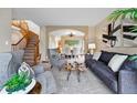 Comfortable living room featuring stylish furniture, neutral tones, and a seamless flow to the dining area at 9515 Dolton Way, Highlands Ranch, CO 80126