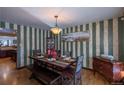 Dining room with wood table and striped wallpaper at 5221 W Rowland Pl, Littleton, CO 80128