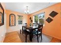 Cozy dining room features a wooden table set, hardwood floors, and large windows for ample natural light at 1332 Ash St, Denver, CO 80220