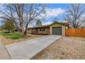 Charming single-story home with a spacious driveway and a cozy front porch, perfect for enjoying the sunset at 482 W Caley Ave, Littleton, CO 80120