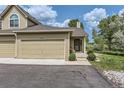 Exterior view showcasing the home's facade, two-car garage and well-maintained landscaping at 10239 W Fair Ave # A, Littleton, CO 80127