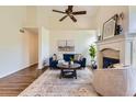 Bright living room featuring a fireplace, vaulted ceilings, and modern decor at 10239 W Fair Ave # A, Littleton, CO 80127