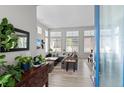 Bright living room featuring large windows, modern furnishings, and a cozy seating area at 4670 Tanner Peak Trl, Brighton, CO 80601