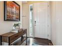 Bright entryway with a console table, artwork, and wood-look flooring at 15162 Jakarta Cir, Parker, CO 80134