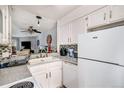 Functional kitchen features white cabinetry, granite countertops, modern appliances, and an open concept layout at 2280 S Jasper Way # B, Aurora, CO 80013