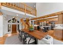 Bright dining area with open staircase to the second level, views into the kitchen, and wooden dining table at 110 Windwood Cir, Breckenridge, CO 80424