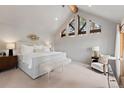 Serene main bedroom with vaulted ceilings, triangular windows, a king bed, and soft neutral tones at 110 Windwood Cir, Breckenridge, CO 80424