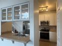 The kitchen features stainless appliances and white cabinetry with a tiled backsplash at 3854 S Dayton St # 308, Aurora, CO 80014