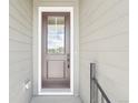 Elegant front door with glass inserts, providing natural light and enhancing the home's entryway at 5909 S Platte Canyon Dr, Littleton, CO 80123
