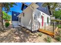 Side view of home with white brick, black trim, and a modern addition at 1029 9Th St, Boulder, CO 80302
