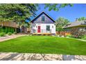 Charming home featuring a red door, manicured lawn, and inviting curb appeal at 1029 9Th St, Boulder, CO 80302