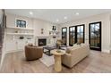 Bright living room boasting a fireplace, hardwood floors, and access to the outdoors through French doors at 1149 S Madison St, Denver, CO 80210