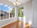 Bright dining area featuring hardwood floors, neutral paint, and abundant natural light through large windows at 3857 Mossy Rock Dr # 201, Highlands Ranch, CO 80126