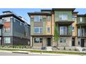 Modern townhouse with multi-tone exterior, stone accents, and landscaped front yard at 815 Promenade Dr, Superior, CO 80027
