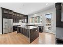 Modern kitchen with an island, stainless steel appliances, and contemporary dark cabinetry at 815 Promenade Dr, Superior, CO 80027