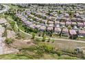 Panoramic aerial view of a residential neighborhood with well-spaced houses, green spaces, and walking paths in a suburban setting at 2307 Candleglow St, Castle Rock, CO 80109