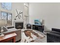 Bright living room with tall windows, fireplace, and modern decor at 4929 W 73Rd Ave, Westminster, CO 80030