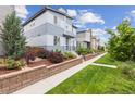 This shows the exterior, including a bit of the yard, with a focus on the home's architecture and curb appeal at 9682 Dunning Cir, Highlands Ranch, CO 80126