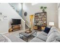 This wide shot showcases an airy living room with its high ceilings, stylish decor, and comfortable seating arrangement at 9682 Dunning Cir, Highlands Ranch, CO 80126