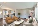 Bright and airy living room with hardwood floors, modern decor, and seamless flow to dining at 1261 S Harrison St, Denver, CO 80210