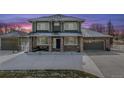 Charming two-story home featuring a well-manicured lawn and a spacious driveway at 16110 Poplar St, Brighton, CO 80602