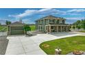 Lovely two-story home with an oversized driveway, detached garage and white fence surrounding the property at 16110 Poplar St, Brighton, CO 80602