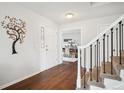 Bright entryway featuring hardwood floors, white walls, and a decorative tree accent at 4 Mountain Ash, Littleton, CO 80127