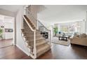 Inviting entryway featuring a staircase with dark wood floors leading to the living room at 4 Mountain Ash, Littleton, CO 80127